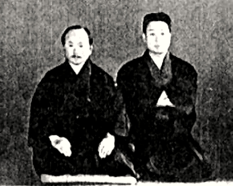 Master Gichin Funakoshi (left) with assistant Takeshi Shimoda (right) - Restored Archival Photo