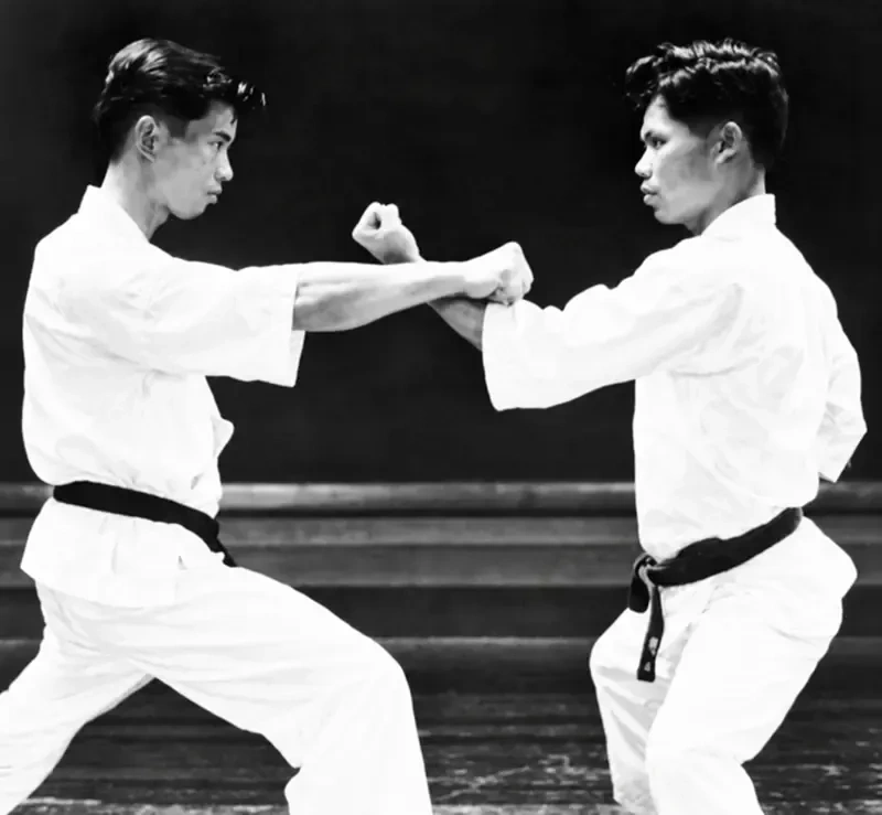 Yoshitaka Funakoshi high upward block against Shigeru Egami lunging punch